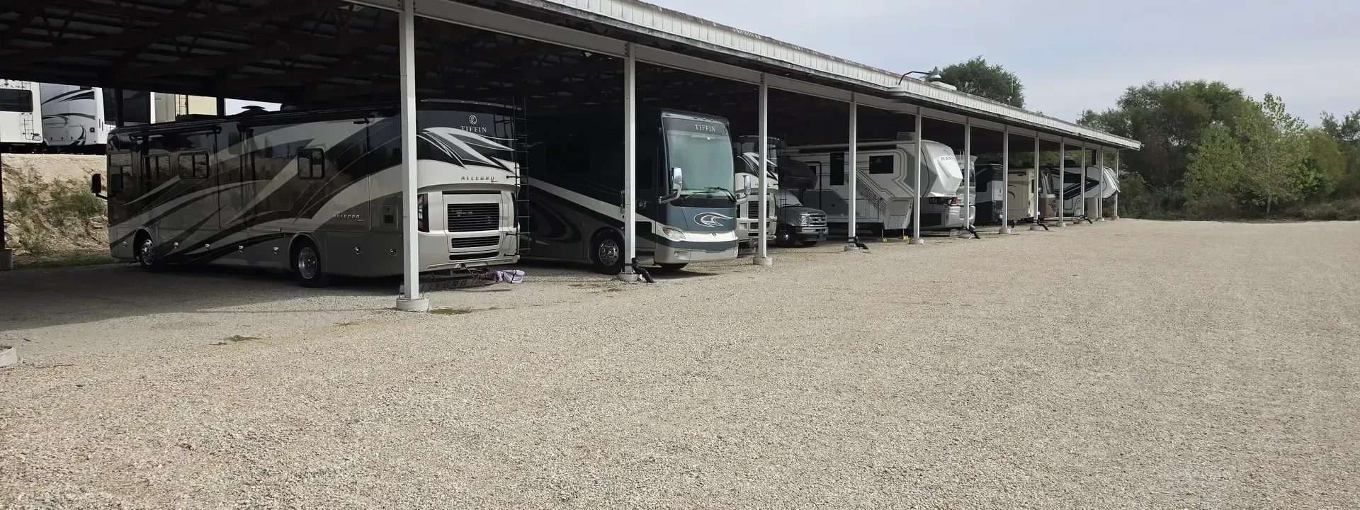 Row of motorhomes and RVs parked under Big River's covered storage structure